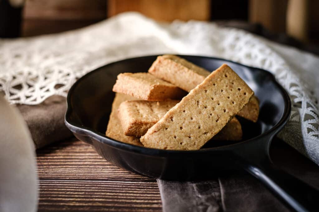 Traditional shortbread finger Scottish Biscuit. set on rustic wooden background.